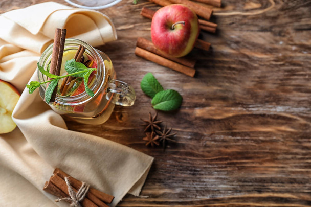 Vasetto massone con sidro di mele e cannella sul tavolo di legno
 - Foto, immagini