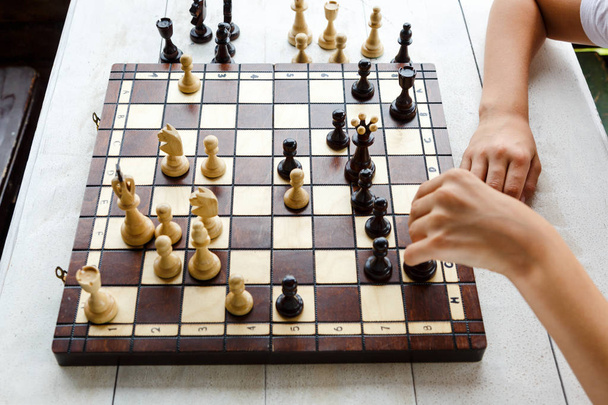 cute young boy makes a move on the chessboard in the class. Education, lesson, training concept - Photo, Image