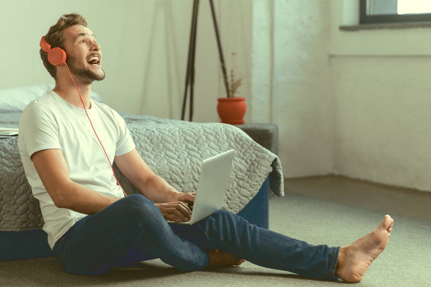 Radiant guy laughing with surprise while watching movie - Photo, Image