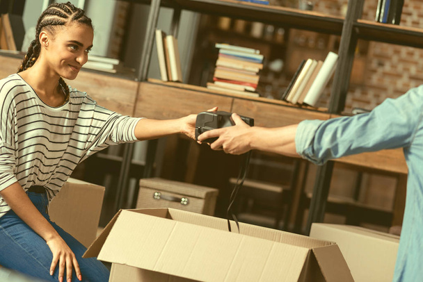 Loving girlfriend helping her soulmate with packing stuff - Photo, image