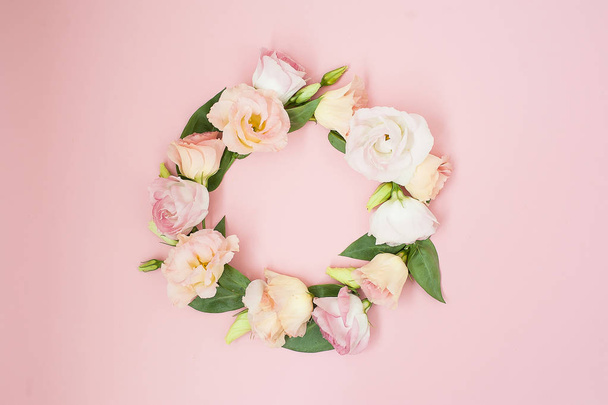 Creative layout made with pink flowers on pastel pink background. Flat lay. Top view, frame with copy space. - 写真・画像