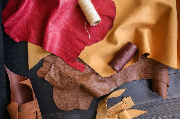 Assortment of colorful leather pieces with threads on table - Fotografie, Obrázek