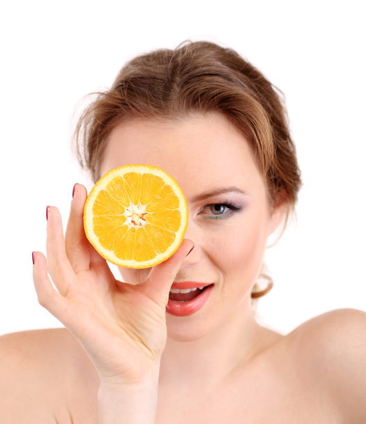 Beautiful young woman with bright make-up, holding orange, isolated on white - 写真・画像