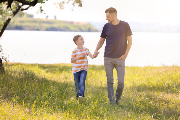 Little boy and his dad walking outdoors - Photo, Image