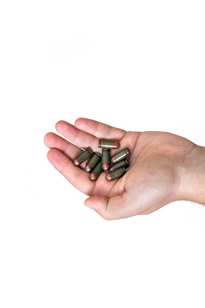 Hands of a man holding ammunition for a old soviet Makarov pistol on white background. - Photo, Image