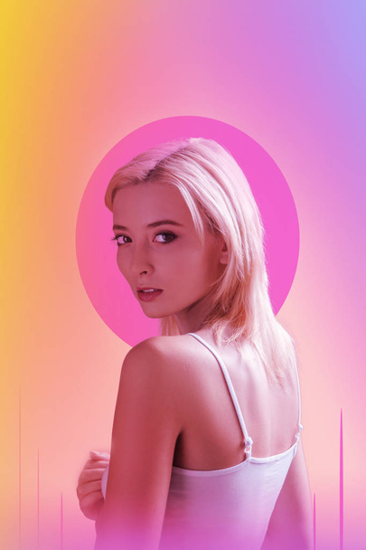 Attractive young woman standing against pink background - Φωτογραφία, εικόνα