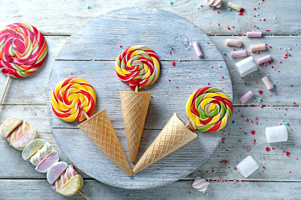 Composition with lollipops and marshmallows on light wooden background - Photo, Image