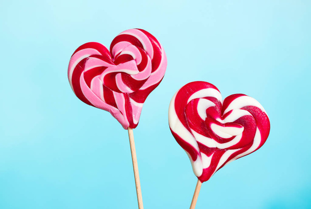 Tasty heart-shaped lollipops on color background - Photo, Image