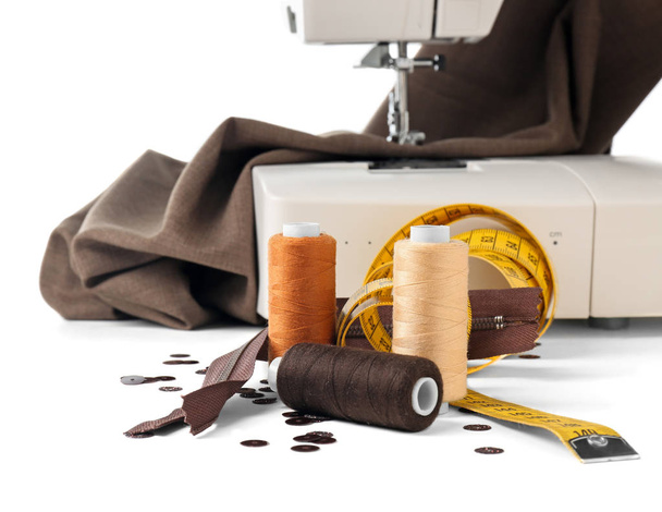 Tailor's supplies near modern sewing machine on white background - Photo, Image