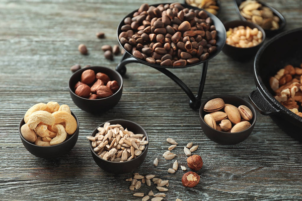 Composition with different nuts on wooden background - Photo, Image