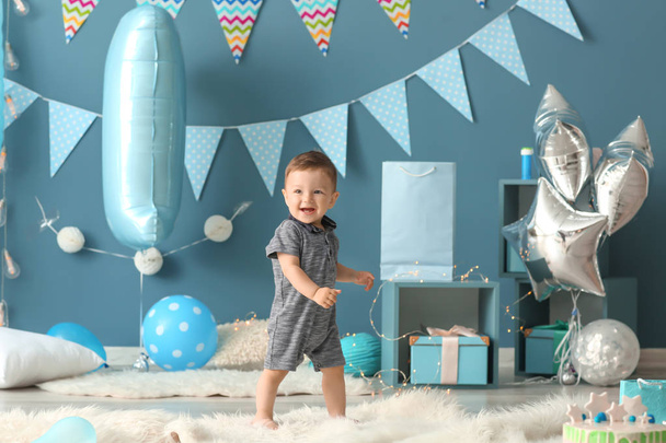 Cute little boy in room decorated for birthday party - Фото, изображение
