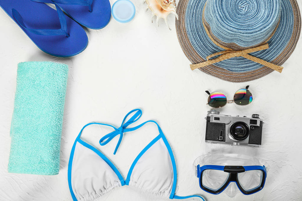 Composition with beach accessories and photo camera on light background - Photo, Image