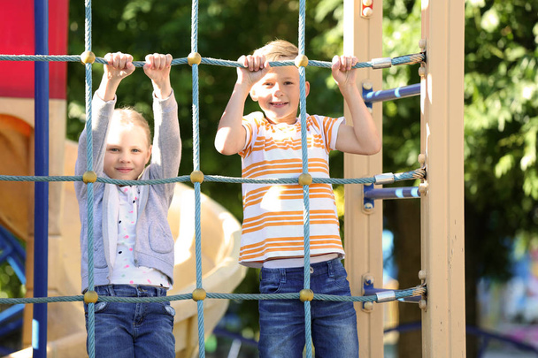 Cute little children having fun outdoors on playground - Foto, Imagem