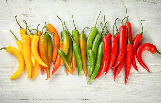 Chili peppers on white wooden background - Foto, Imagem