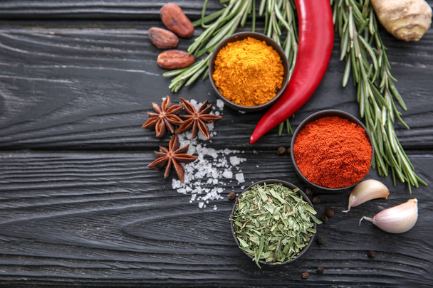 Composition with different spices on wooden background - Foto, Imagem