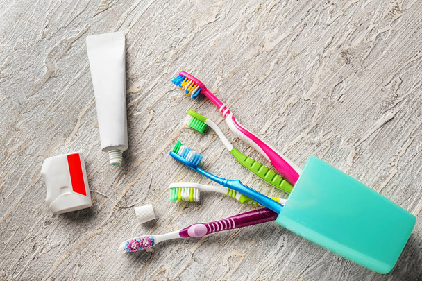 Toothbrushes, dental floss and paste on wooden background - Photo, Image
