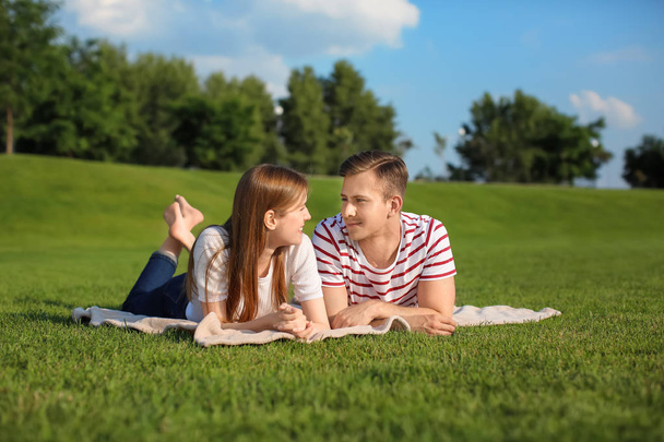 Young couple lying on plaid outdoors - Foto, Bild