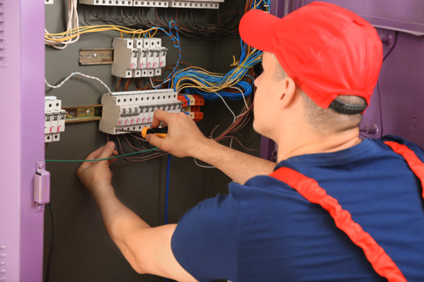 Electrician repairing distribution board - Photo, Image