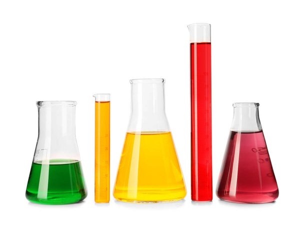 Laboratory glassware with colorful liquids on white background - Photo, Image