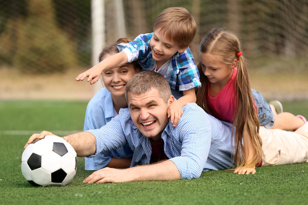 Happy family with soccer ball outdoors - Fotoğraf, Görsel