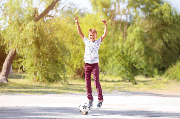 Little boy playing football outdoors - Foto, Imagem