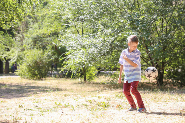 Little boy playing football outdoors - Zdjęcie, obraz