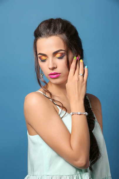 Beautiful young woman with professional manicure on color background - Фото, зображення