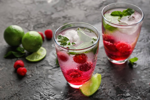 Glasses of fresh raspberry mojito on table - Valokuva, kuva