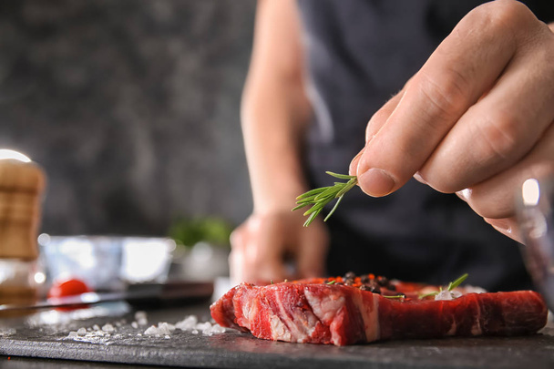 Man preparing meat in kitchen, closeup - Photo, Image