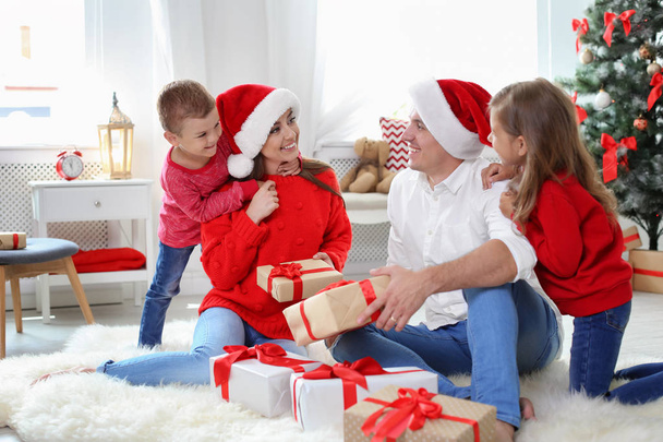 Happy parents and child having fun near Christmas tree at home - Fotoğraf, Görsel