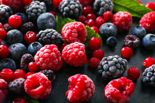 Delicious frozen berries on grey background - Photo, Image