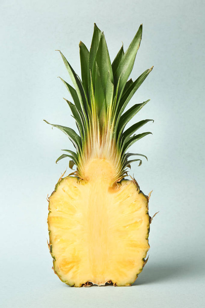 Half of ripe pineapple on light background - Valokuva, kuva