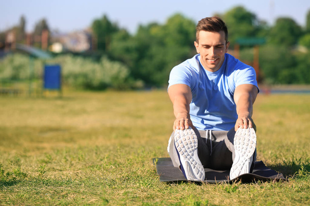 Sporty young man training outdoors - 写真・画像