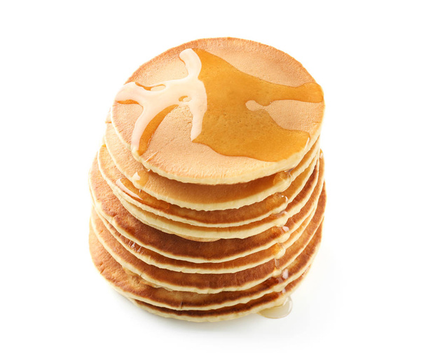 leckere Pfannkuchen mit Honig auf weißem Hintergrund - Foto, Bild