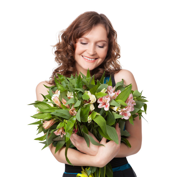 Portrait of pretty brunette holding bouquet of flowers - Fotografie, Obrázek