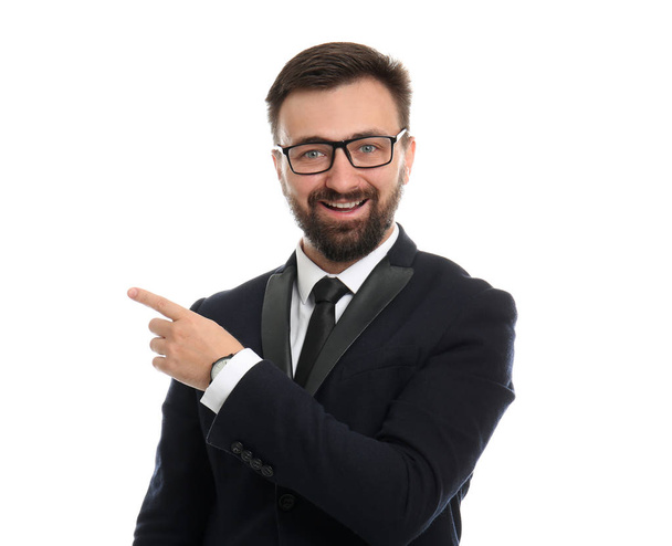 Handsome businessman pointing at something on white background - 写真・画像