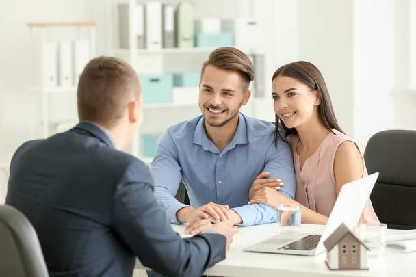 Real estate agent working with clients in office - Fotó, kép