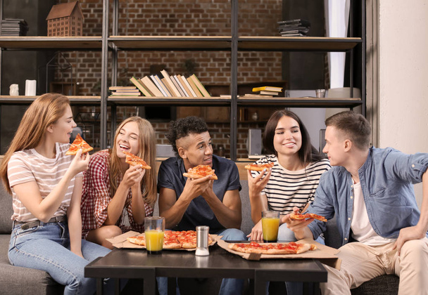 Young people having fun at party with delicious pizza indoors - Foto, Imagem