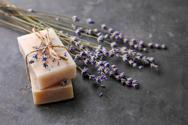 Beautiful lavender and soap on dark table - Photo, Image