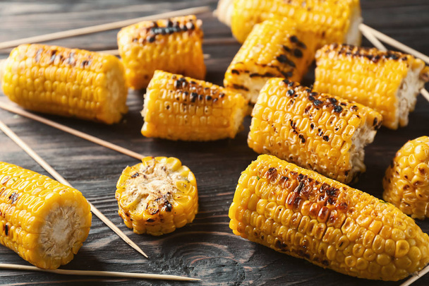 Delicious grilled corn on wooden table, closeup - Photo, Image