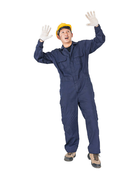 Portrait of a workman with blue coveralls and hardhat in a uniform on white background with clipping path - Photo, Image