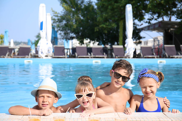 Cute children in swimming pool on summer day - Photo, Image