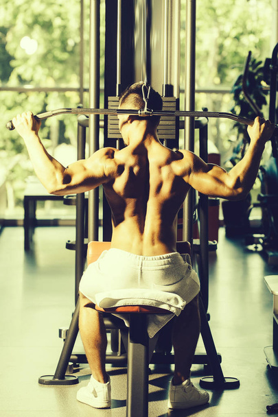 muscular man training in gym - Photo, image