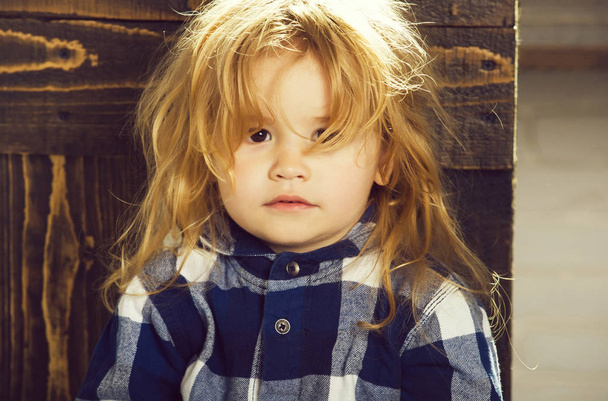 cute little boy with blonde hair in blue checkered shirt - Fotografie, Obrázek