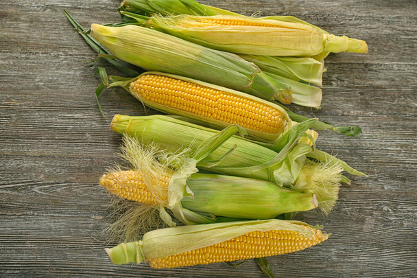 Fresh corn cobs on wooden table - Φωτογραφία, εικόνα