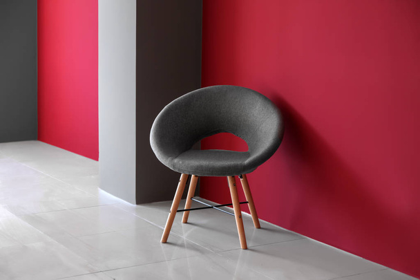Comfortable chair near color wall - Photo, Image