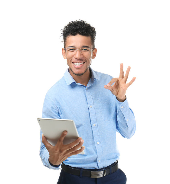 Handsome African-American businessman with tablet computer on white background - Foto, immagini