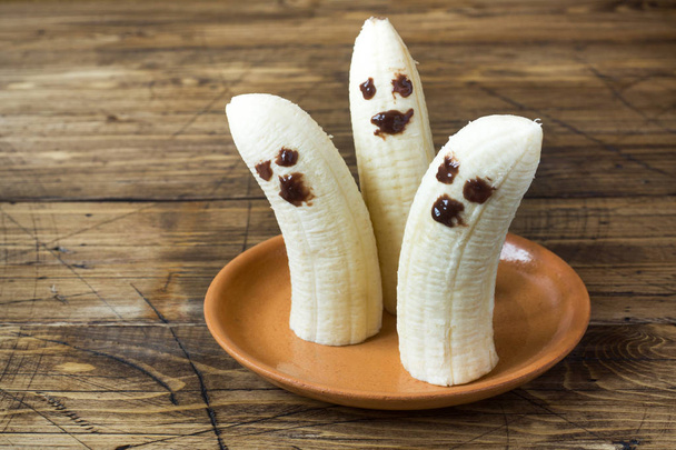 Painted funny faces on bananas for Halloween. - Photo, Image