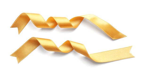 Fitas douradas enroladas no fundo branco
 - Foto, Imagem