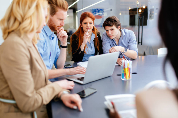 Business people brainstorming in white modern office at desk - Fotó, kép